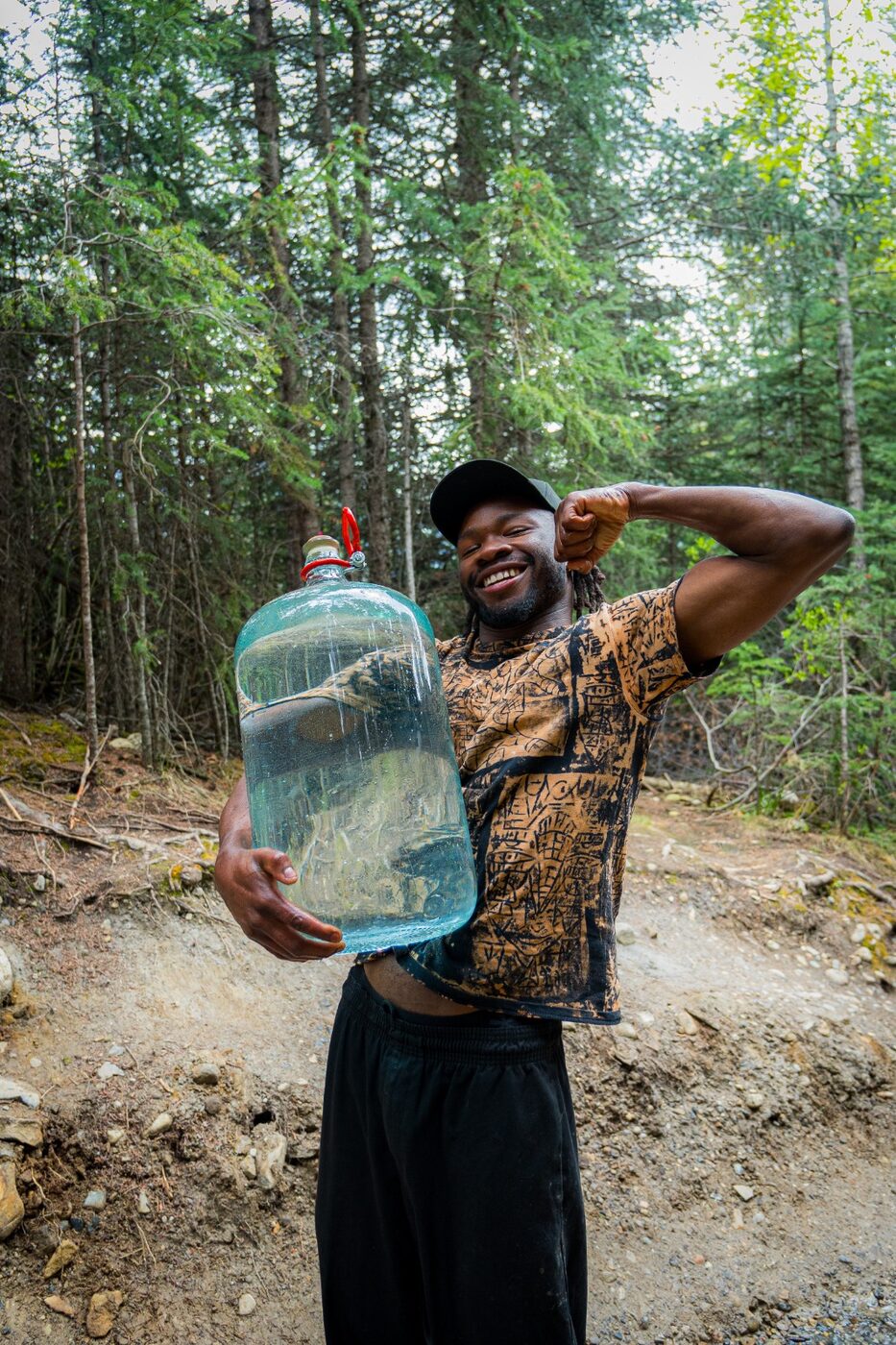 Gabriel holding water in the forest