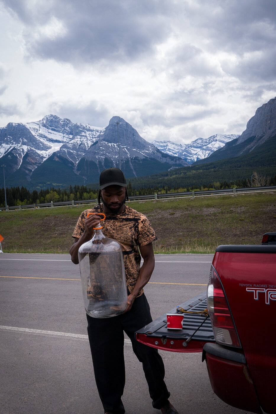 Gabriel with GloryAde bottles in the mountains